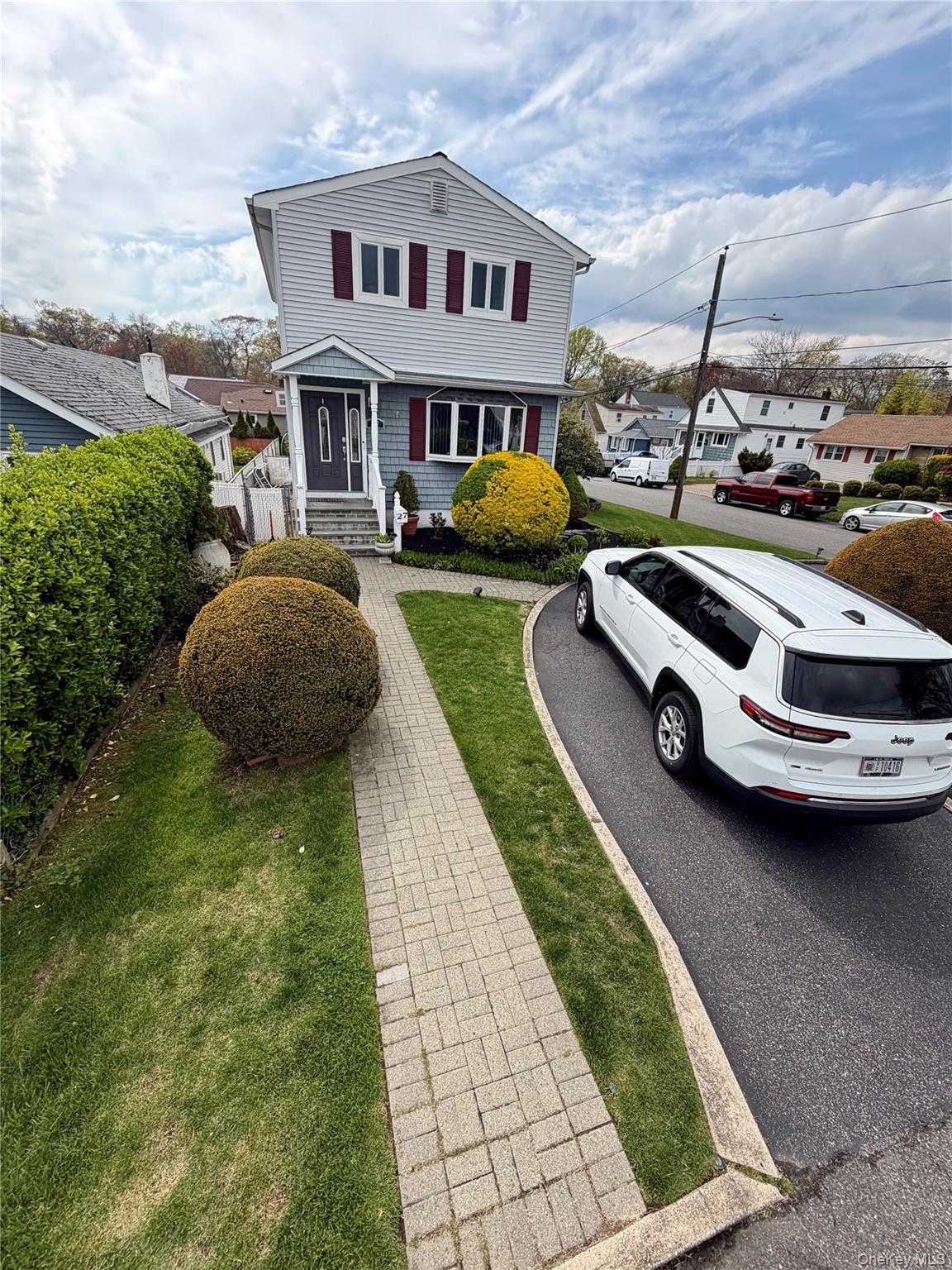 27 Colonial Road Copiague, NY 11726 - Photo 2 of 15 a car parked on the side of the road