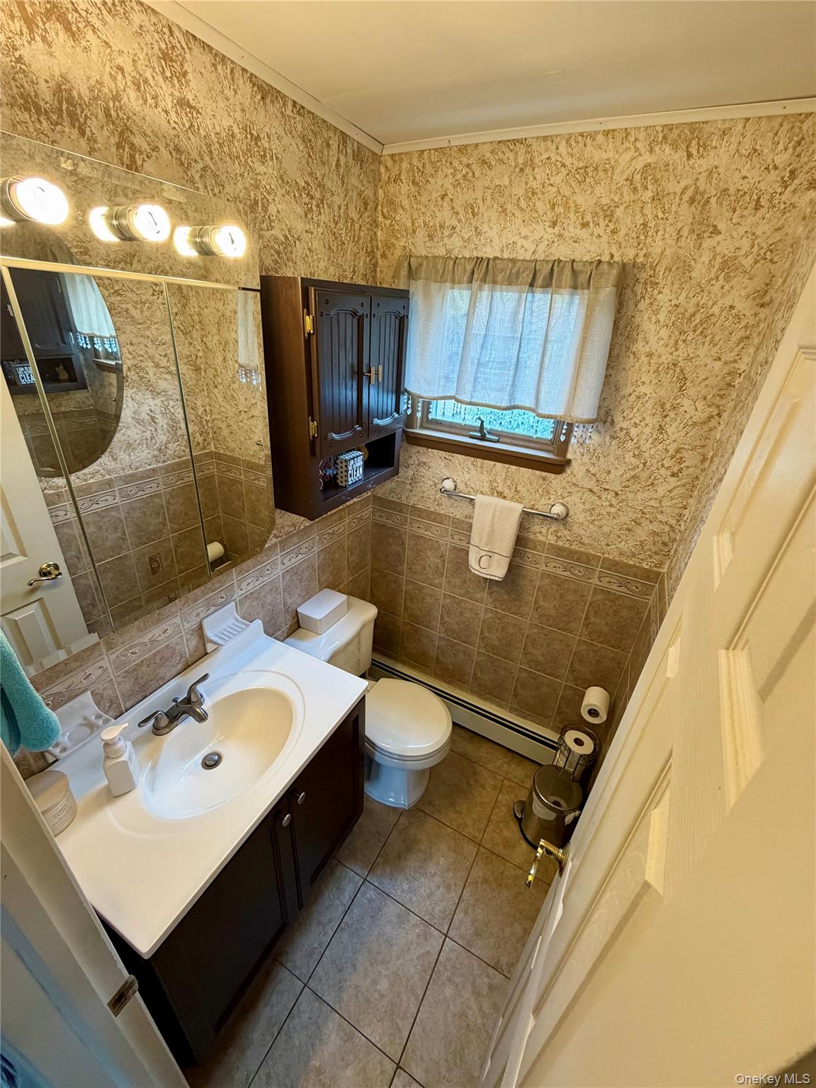 27 Colonial Road Copiague, NY 11726 - Photo 7 of 15 a bathroom with a sink a toilet and shower