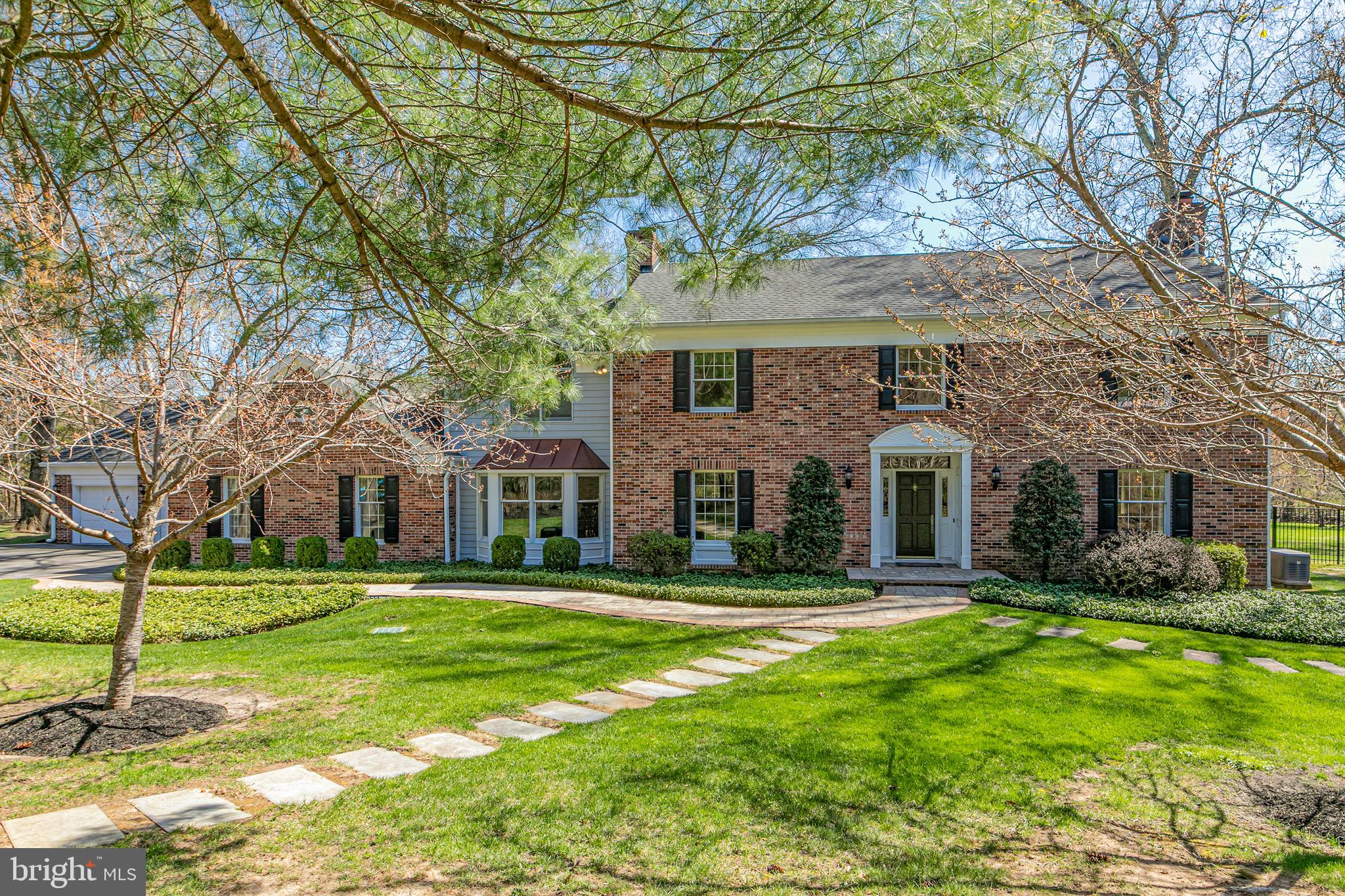 a front view of house with yard and green space