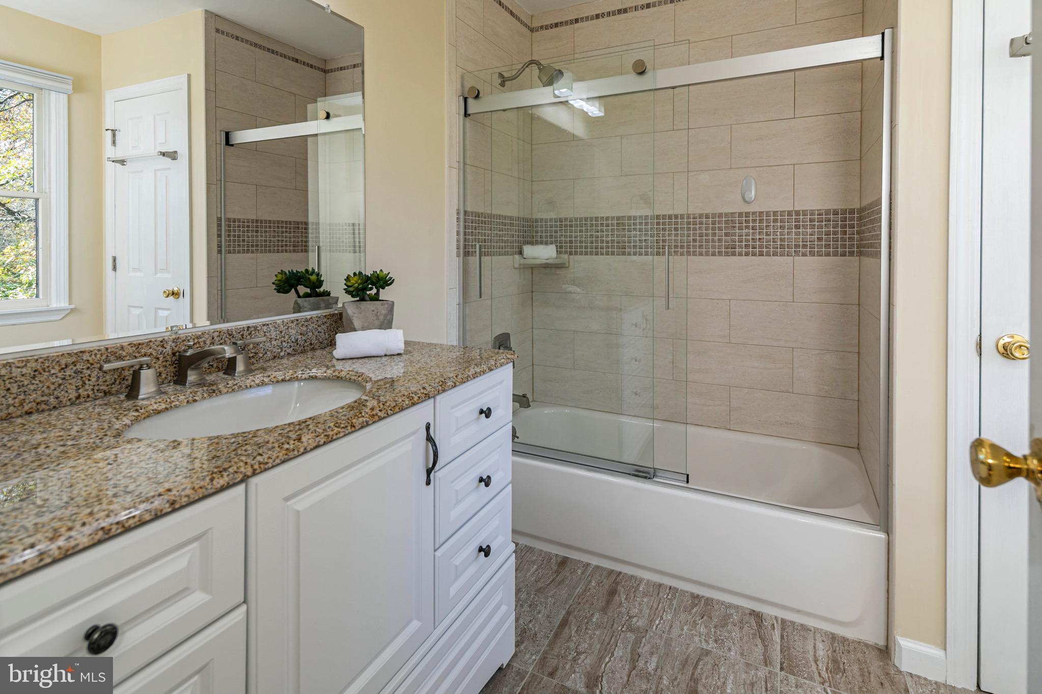 8 Winfield Road Princeton, NJ 08540 - Photo 44 of 52 a bathroom with a granite countertop sink a mirror and a bathtub