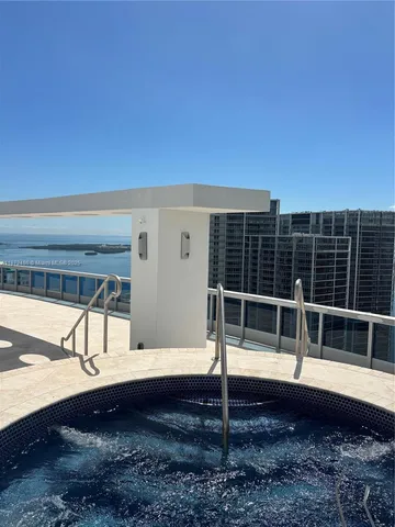 a spacious bedroom with a bed a table and window