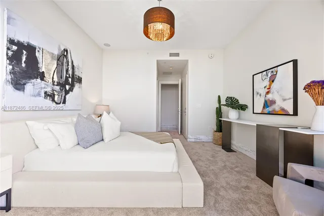 a large living room with large couches and painting on the wall