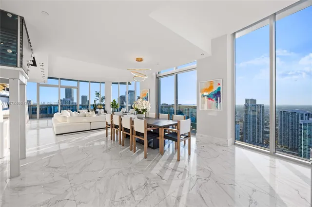 a large kitchen with kitchen island a large window a sink and cabinets