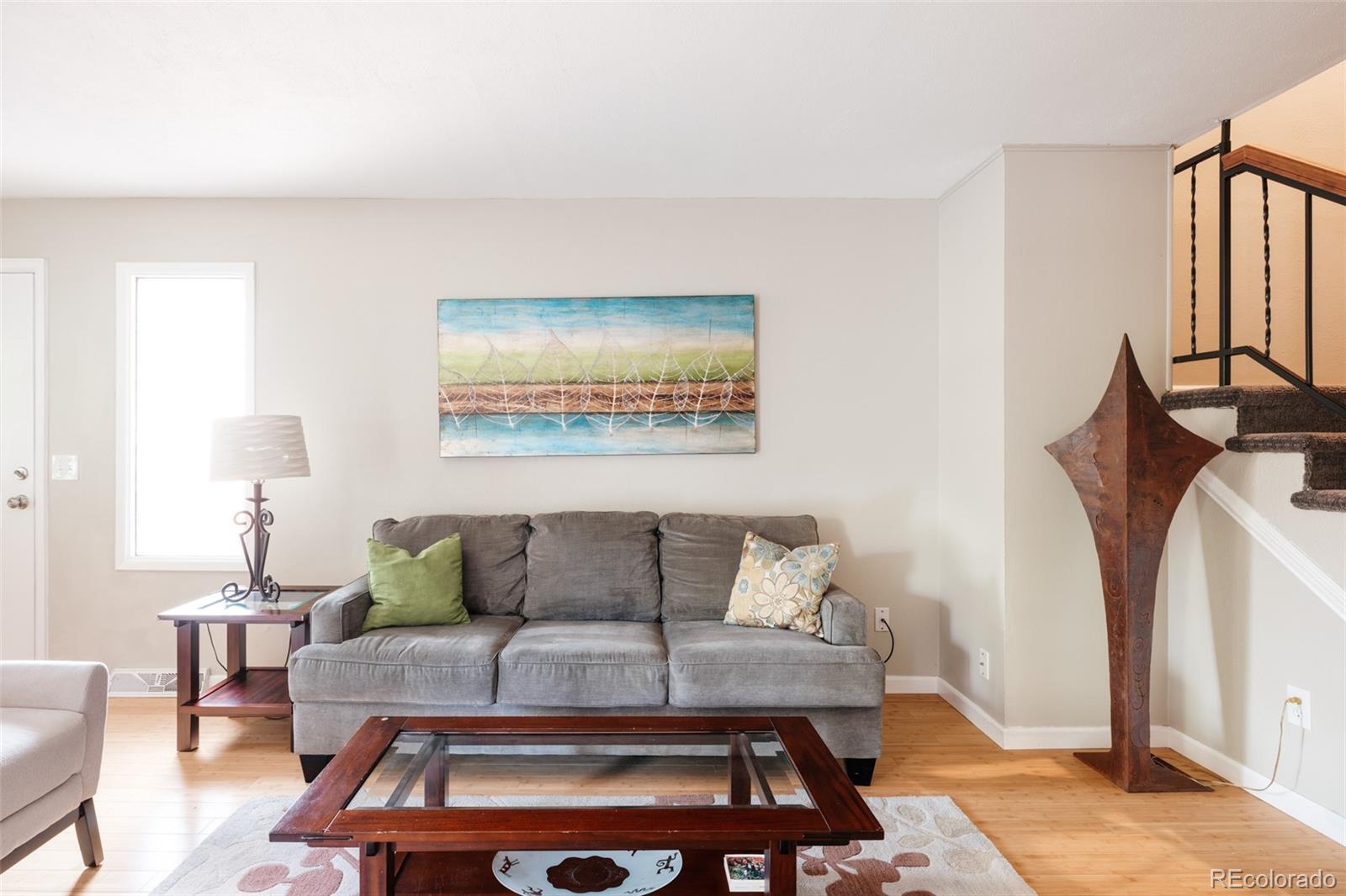 7448 West Roxbury Place Littleton, CO 80128 - Photo 11 of 30 a living room with furniture a rug and a window