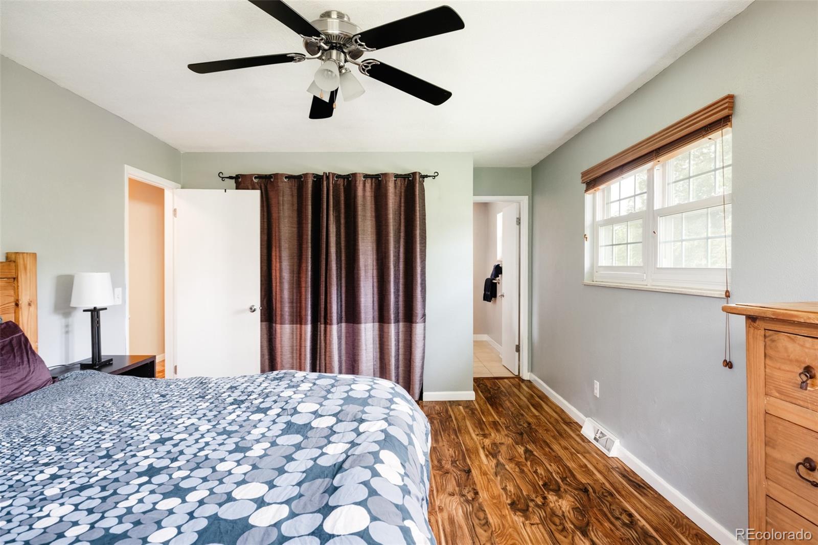 7448 West Roxbury Place Littleton, CO 80128 - Photo 18 of 30 a bedroom with a bed and a window