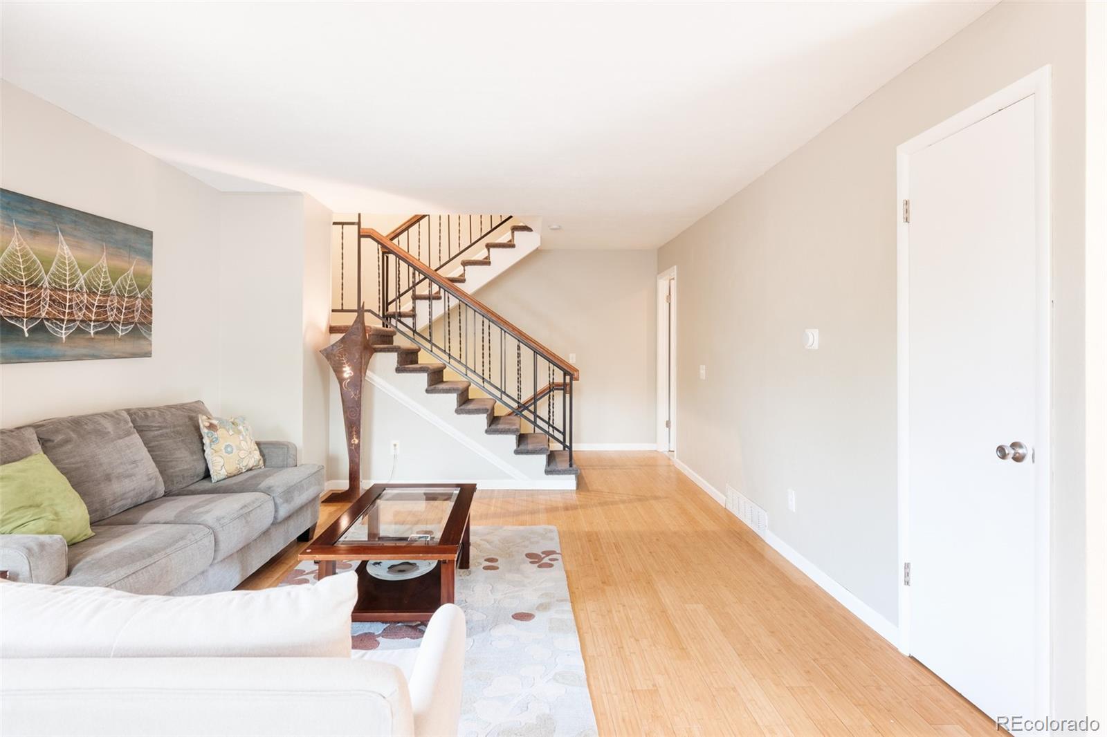 7448 West Roxbury Place Littleton, CO 80128 - Photo 2 of 30 a living room with furniture and stairs