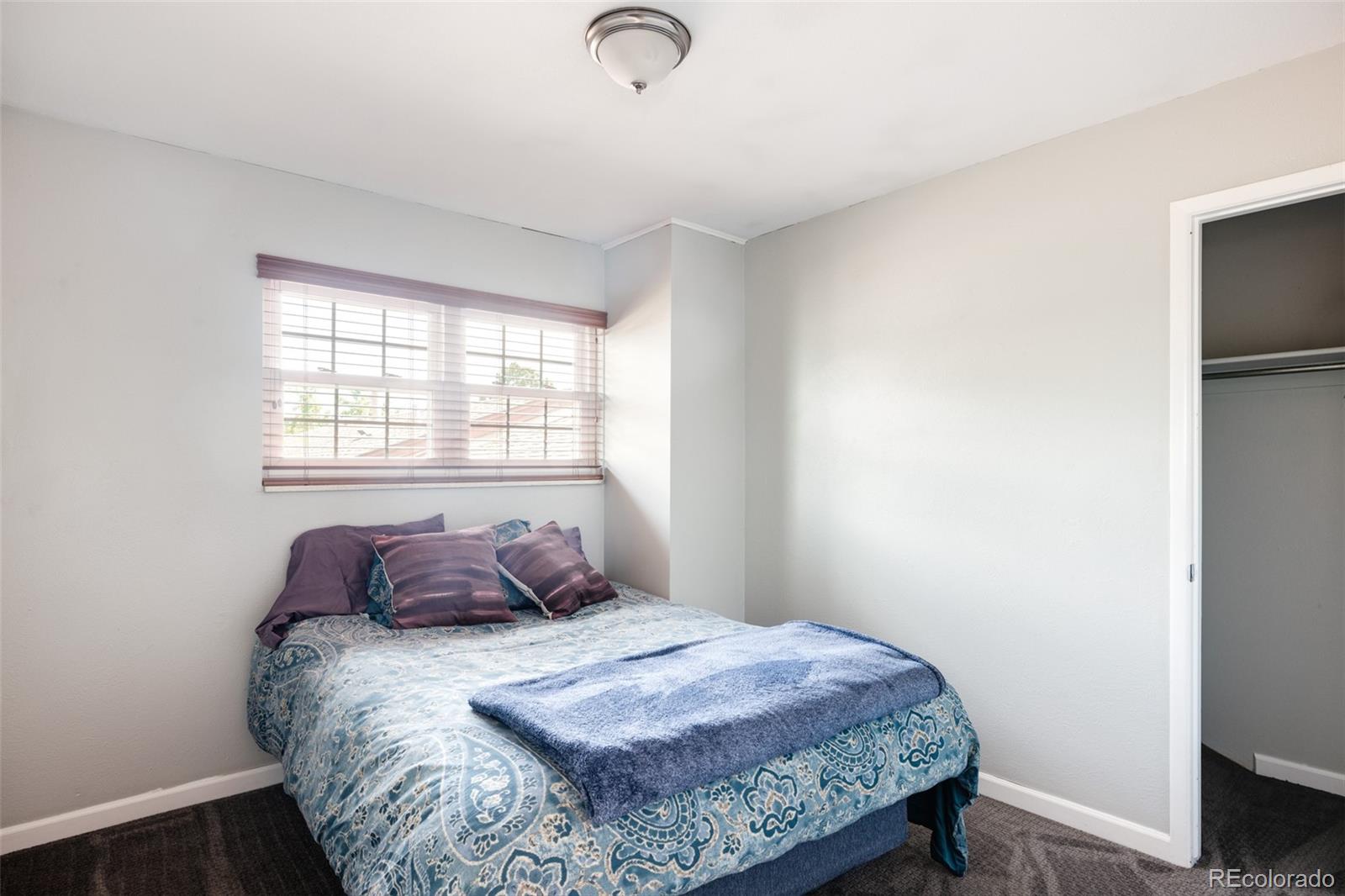 7448 West Roxbury Place Littleton, CO 80128 - Photo 21 of 30 a bedroom with a bed and with a window