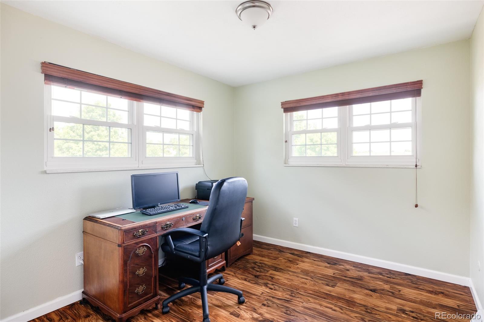 7448 West Roxbury Place Littleton, CO 80128 - Photo 22 of 30 a view of workspace with wooden floor windows