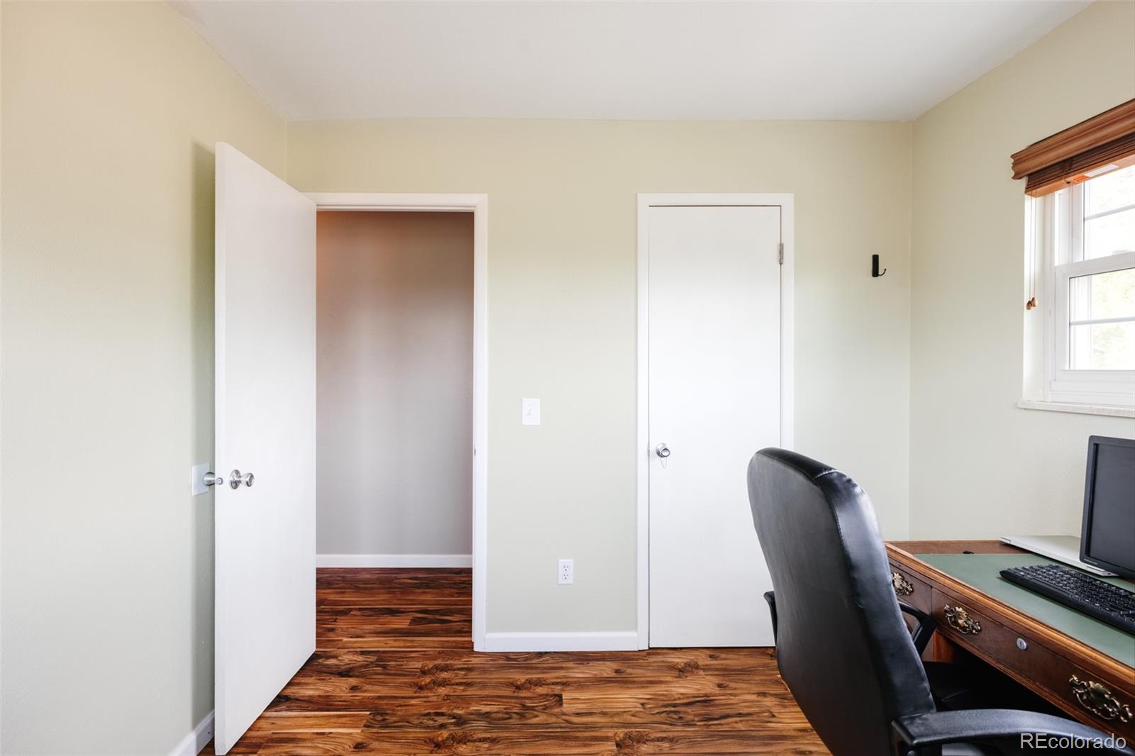 7448 West Roxbury Place Littleton, CO 80128 - Photo 23 of 30 a view of room with wooden floor and chair
