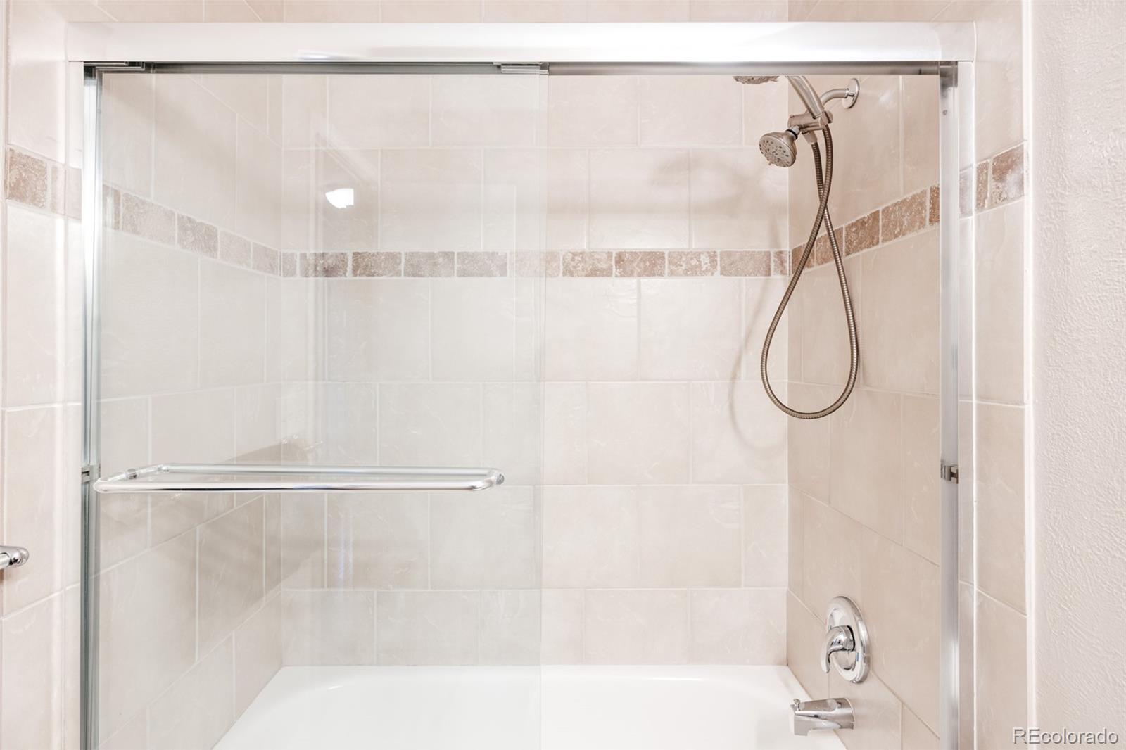 7448 West Roxbury Place Littleton, CO 80128 - Photo 25 of 30 a bathroom that has a glass shower door