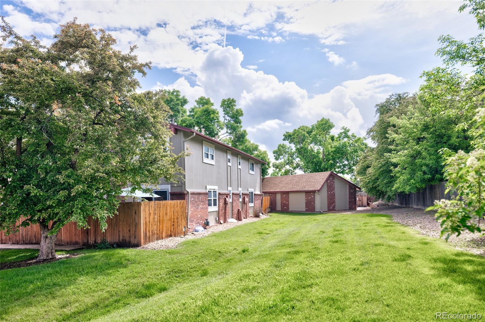 7448 West Roxbury Place Littleton, CO 80128 - Photo 28 of 30 a view of a house with a yard and a tree