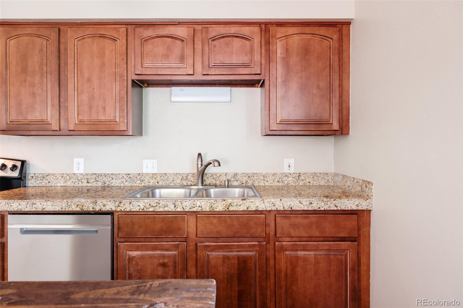 7448 West Roxbury Place Littleton, CO 80128 - Photo 9 of 30 a kitchen with granite countertop stainless steel appliances sink and cabinets