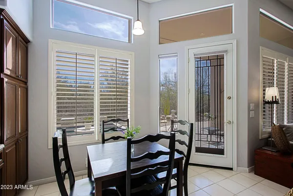 a kitchen with a sink a kitchen island stainless steel appliances a window and dining table