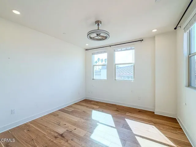 a view of a room with a window and ceiling fan