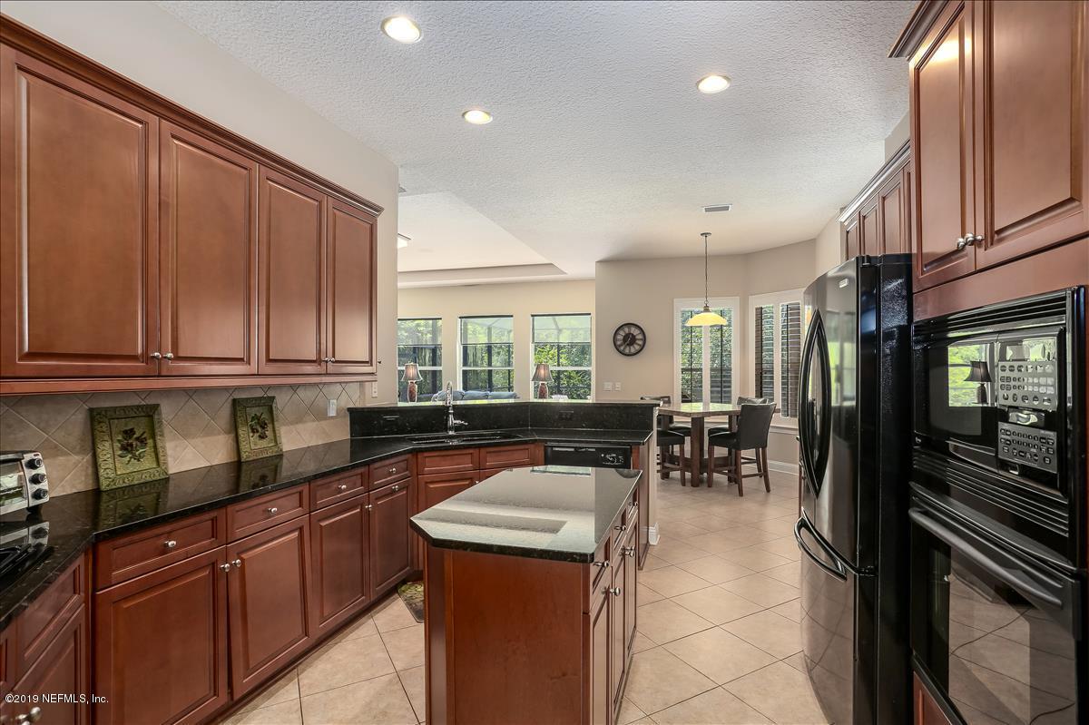 508 Sebastian Square St. Augustine, FL 32095 - Photo 15 of 46 a kitchen with granite countertop sink cabinets and stainless steel appliances