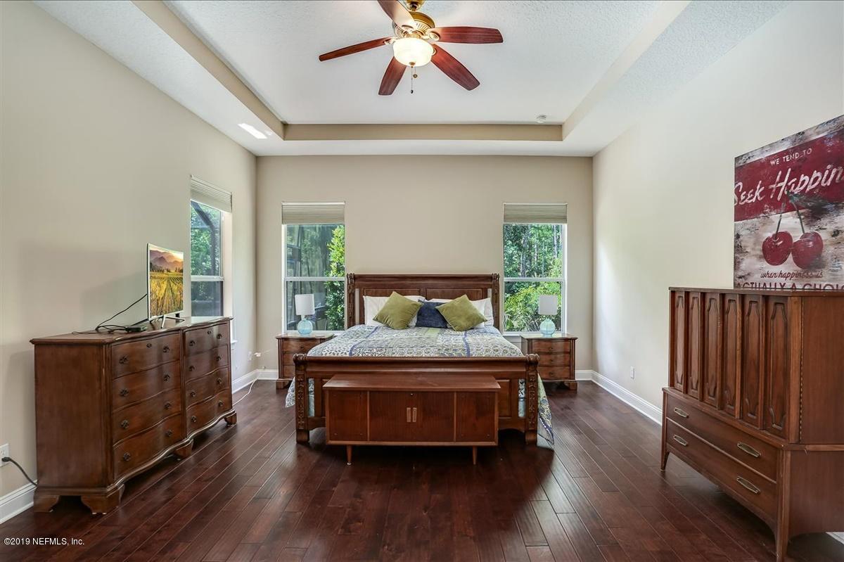 508 Sebastian Square St. Augustine, FL 32095 - Photo 24 of 46 a bedroom with a bed and wooden floor