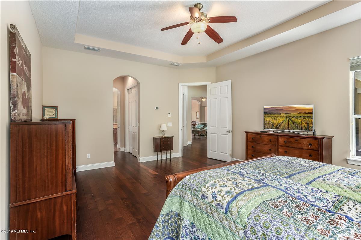 508 Sebastian Square St. Augustine, FL 32095 - Photo 25 of 46 a bedroom with a bed and wooden floor