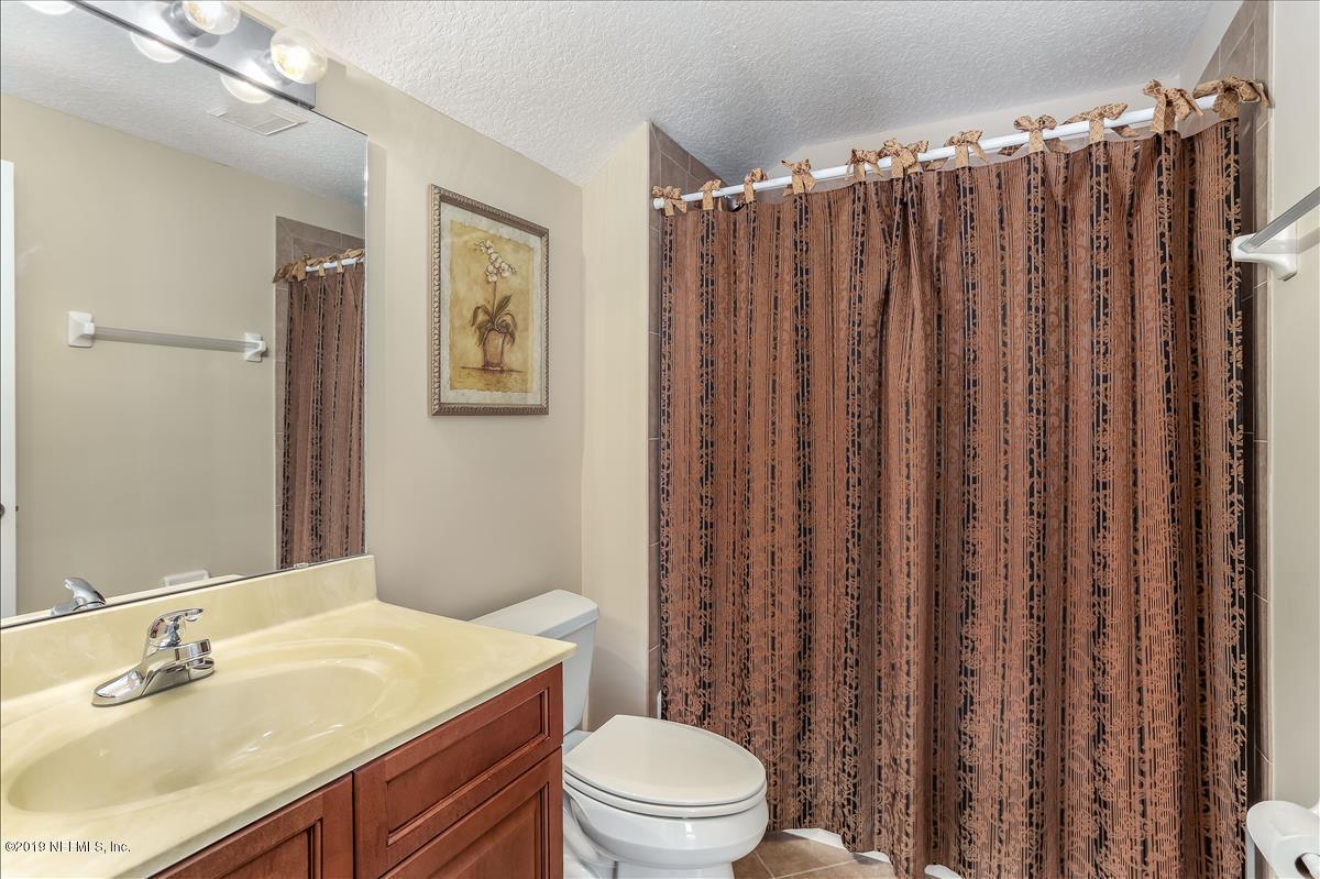 508 Sebastian Square St. Augustine, FL 32095 - Photo 37 of 46 a bathroom with a granite countertop toilet a sink and a mirror