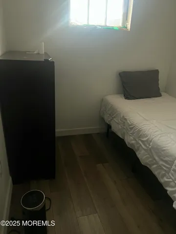 a bed sitting in a bedroom next to a window