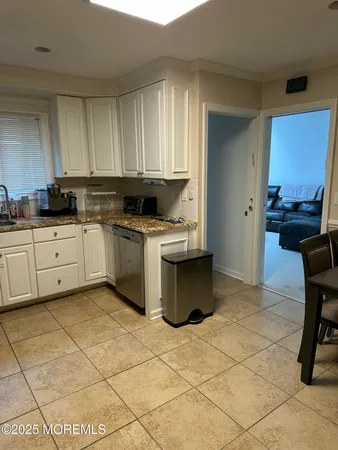 a kitchen with a stove a sink a counter top space and cabinets