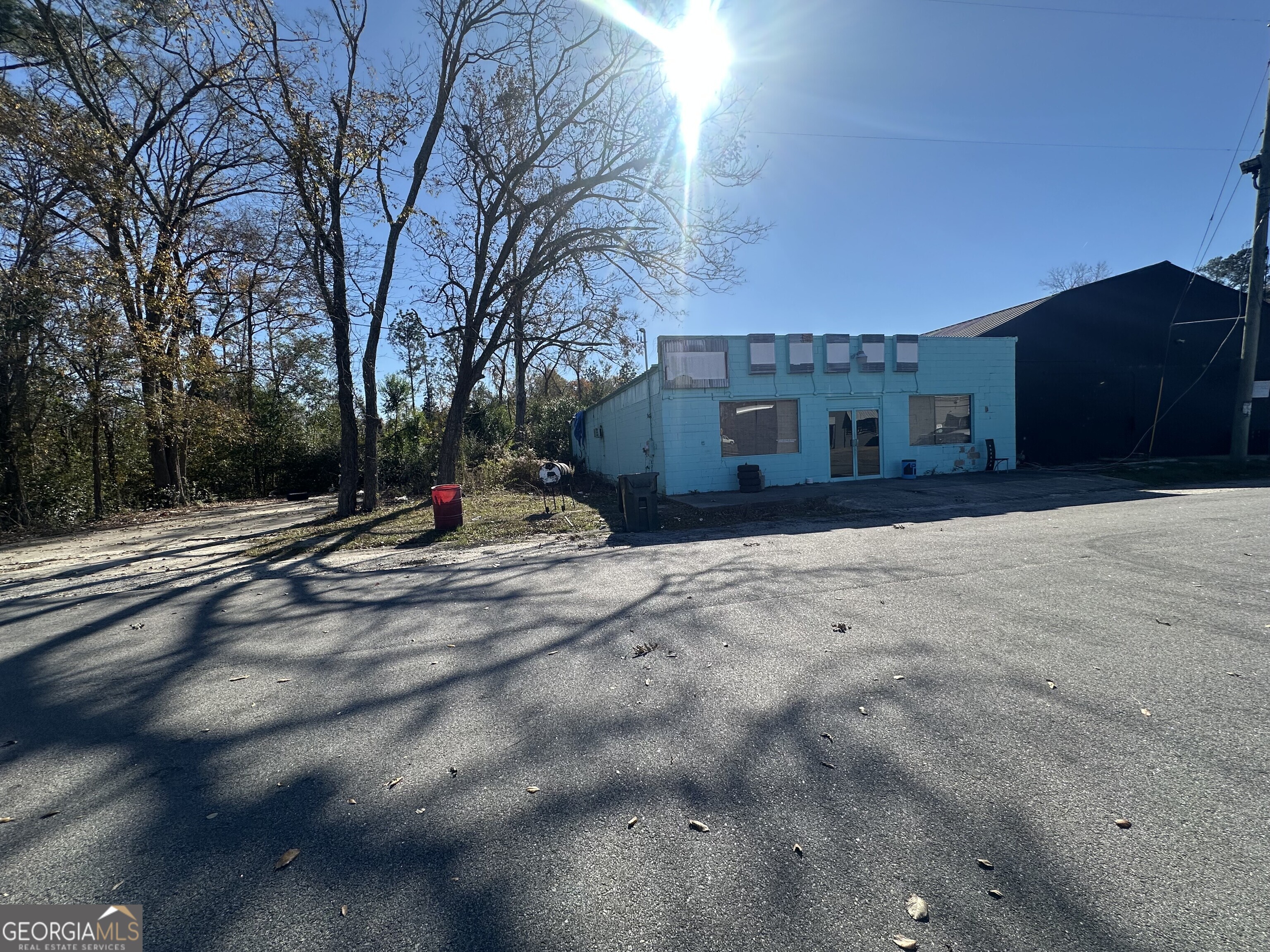 326 Scarboro Street Wadley, GA 30477 - Photo 2 of 3 a street view with large trees