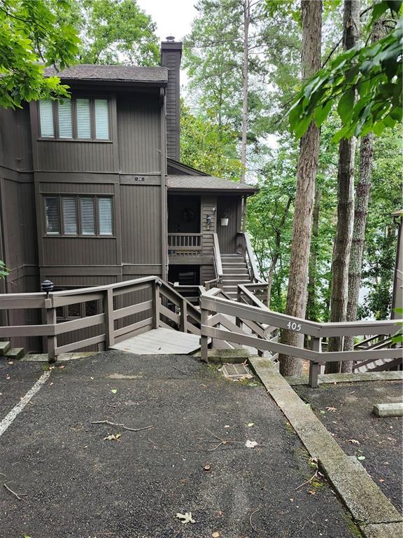 a view of house with backyard space and balcony