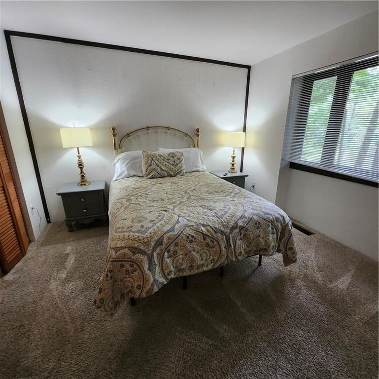 34 Sconti Ridge, Unit 405 Jasper, GA 30143 - Photo 12 of 14 a bedroom with a bed and window