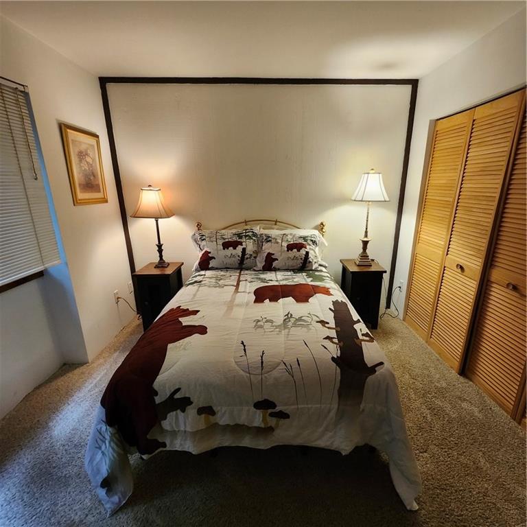 34 Sconti Ridge, Unit 405 Jasper, GA 30143 - Photo 10 of 14 a bed sitting in a bedroom next to a window