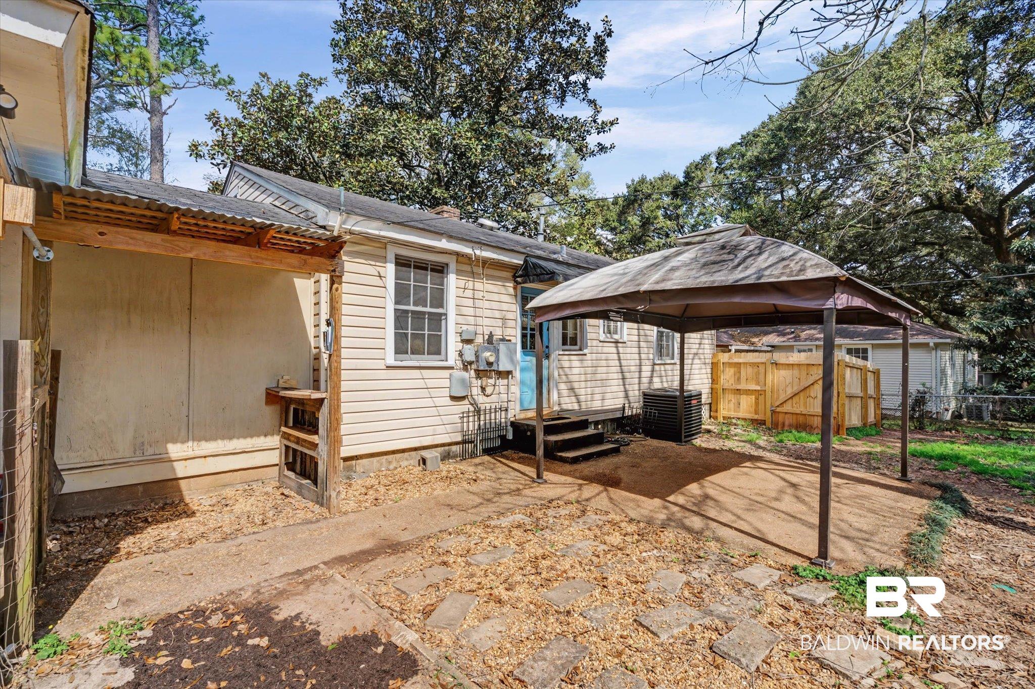 5117 Norton Lane Mobile, AL 36608 - Photo 22 of 35 Back of house with a gazebo, a detached carport, and a patio area