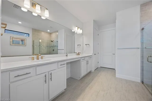 a large bathroom with a double vanity sink and mirror