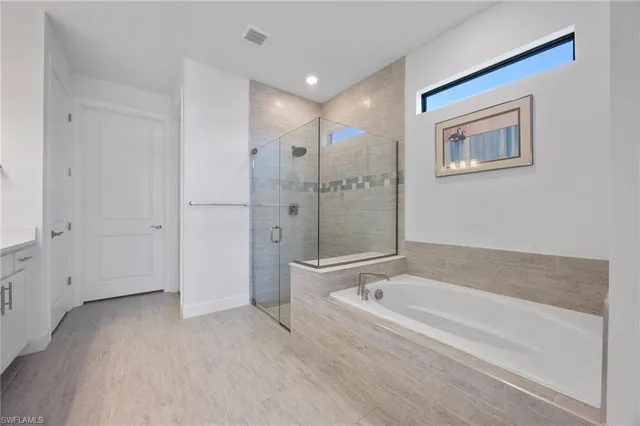 a spacious bathroom with a bathtub and a shower