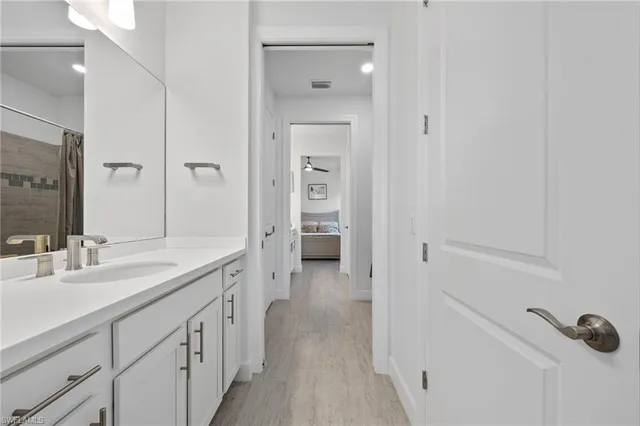 a spacious bathroom with a granite countertop sink mirror and toilet
