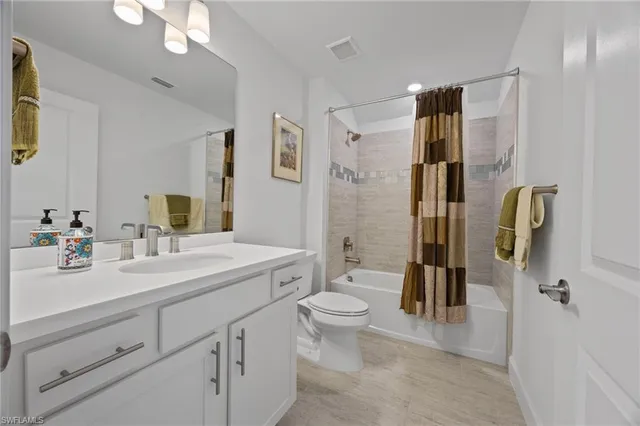 a spacious bathroom with a shower sink vanity mirror and toilet