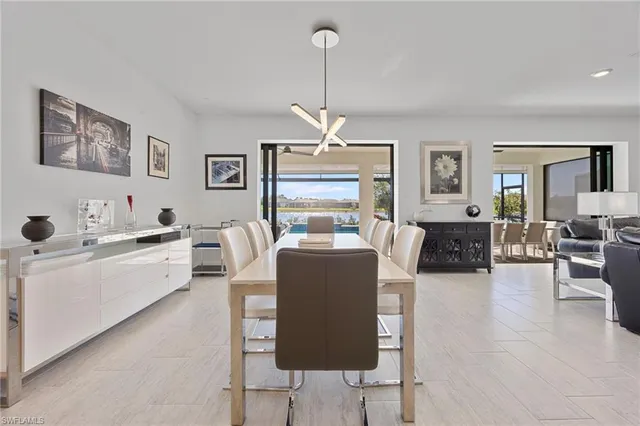 a living room with furniture a large window and kitchen view