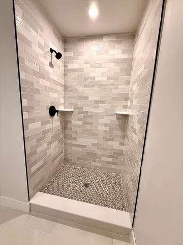 a bathroom with a glass door shower