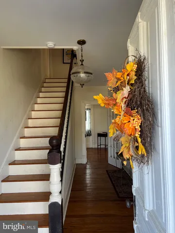 a view of entryway and hall with wooden floor