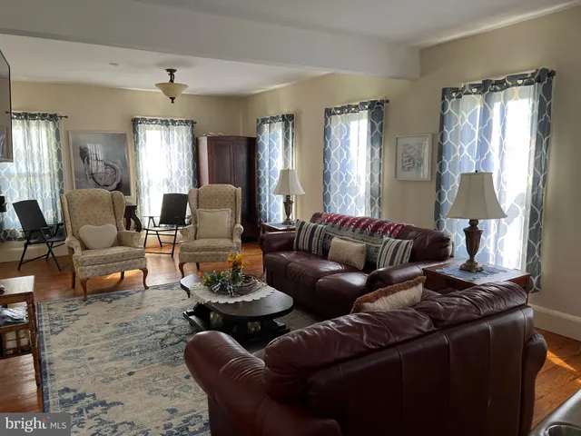 a living room with furniture fireplace and a window