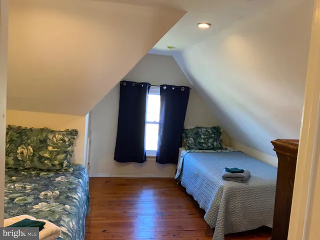 a bedroom with bed and a window