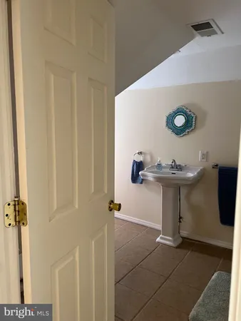 a bathroom with a sink a mirror and shower