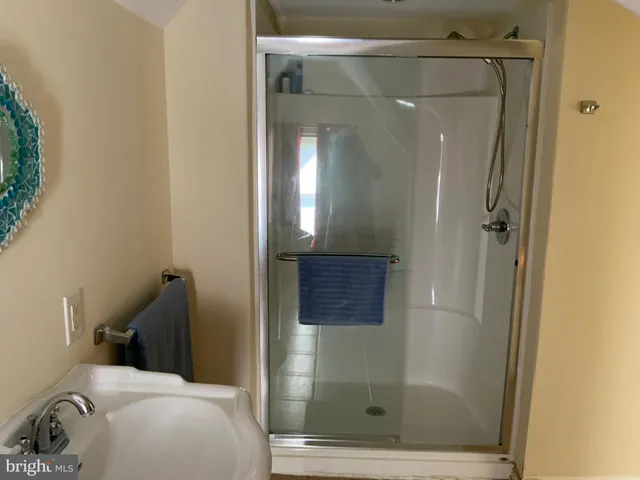 a view of a hallway to a room with wooden floor and staircase