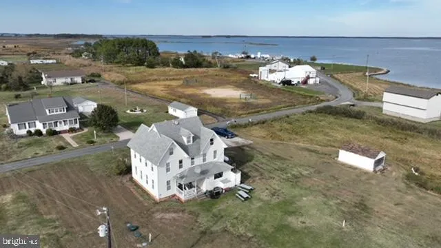 an aerial view of a house with a yard and lake view