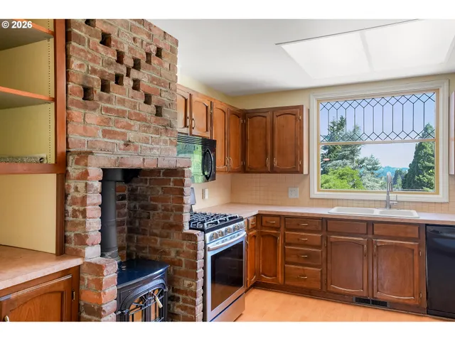 a kitchen with granite countertop a stove and a sink