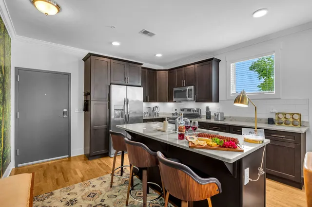 a kitchen with a sink refrigerator and cabinets