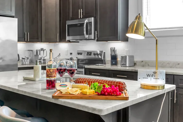 a kitchen with stainless steel appliances kitchen island granite countertop a sink and cabinets