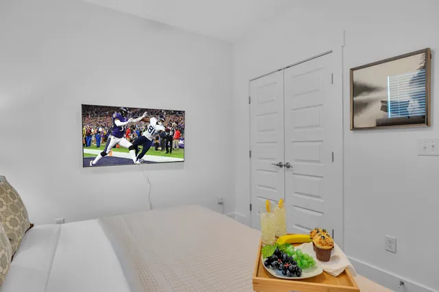 a bedroom with a bed and painting on the wall