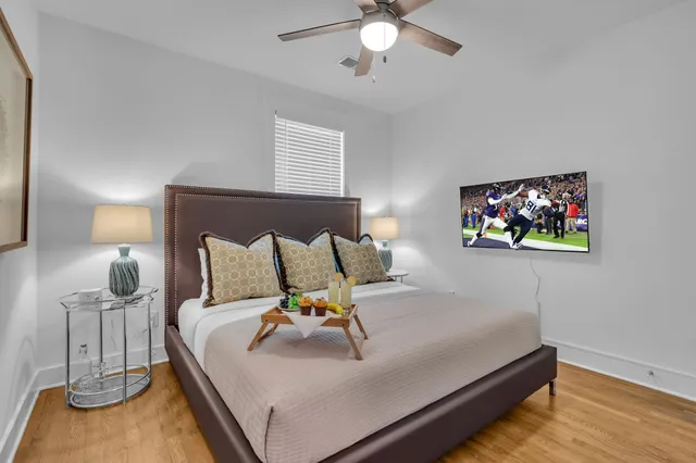 a bed sitting in a bedroom next to a lamp