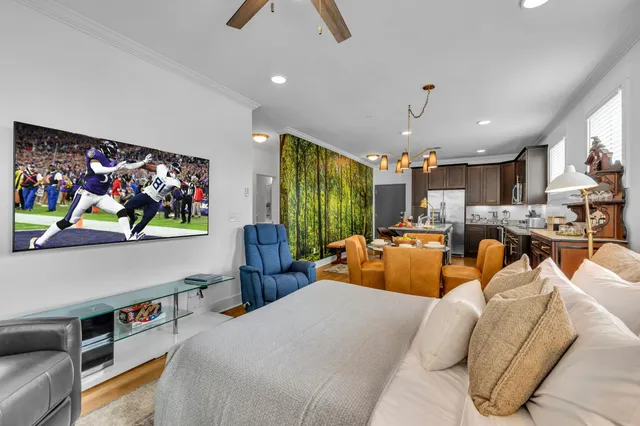 a bedroom with furniture and a flat screen tv