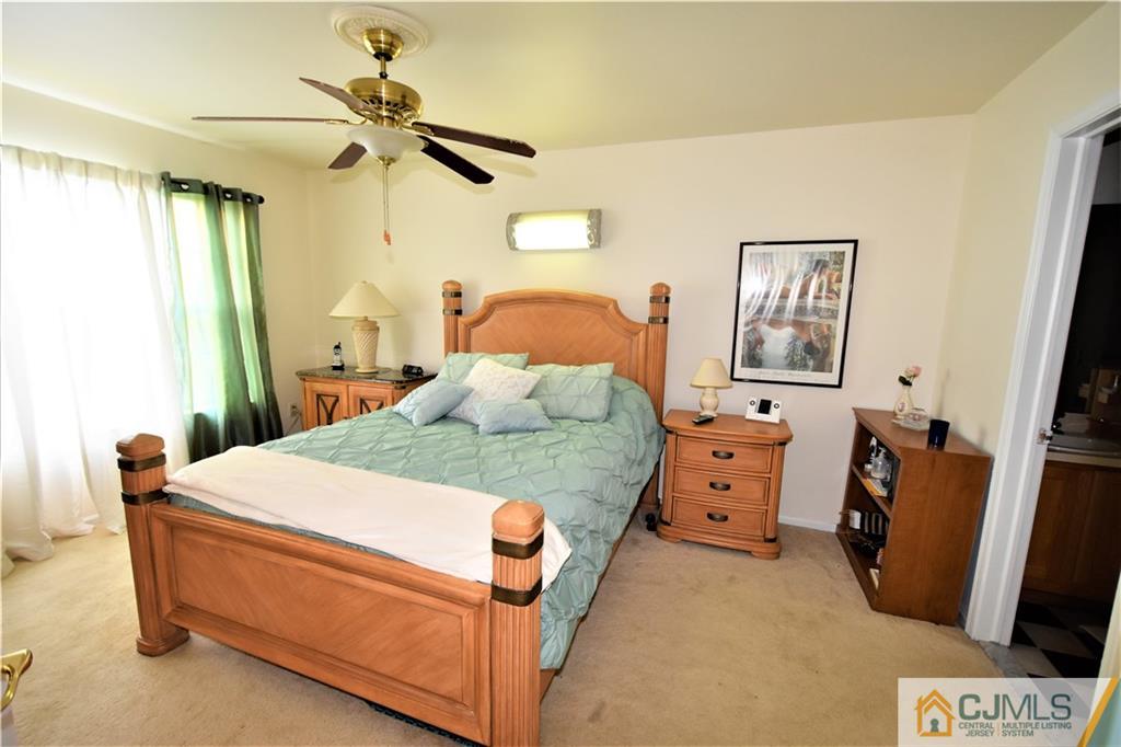 304 Hawthorne Road North Brunswick, NJ 08902 - Photo 13 of 25 a bedroom with a bed and a mirror