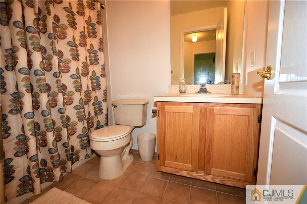 304 Hawthorne Road North Brunswick, NJ 08902 - Photo 17 of 25 a bathroom with a sink toilet and shower
