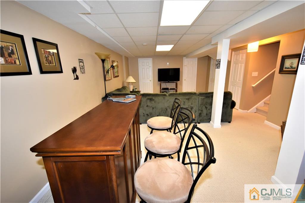 304 Hawthorne Road North Brunswick, NJ 08902 - Photo 20 of 25 a view of a dining room with furniture and a flat screen tv